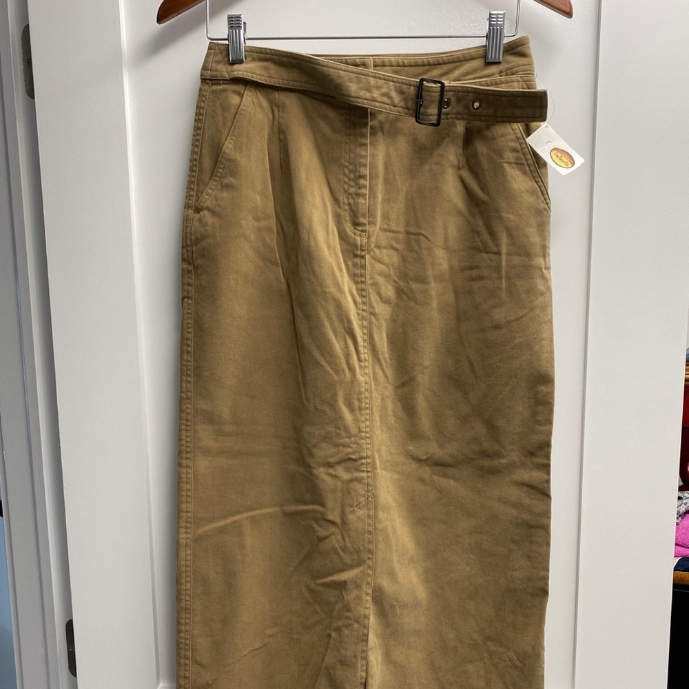 Ankle length, front slit, built in belt. “Suede” feel skirt